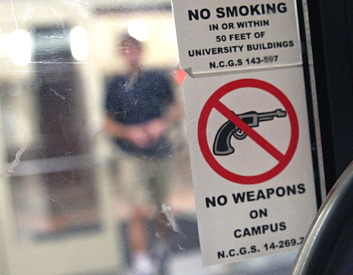 Signs like the one pictured on a library door are posted on all entrances to campus buildings. The Students for Concealed Carry will wear empty holsters though the week in protest of university policies that ban firearms on campus. Paul Heckert | The Appalachian